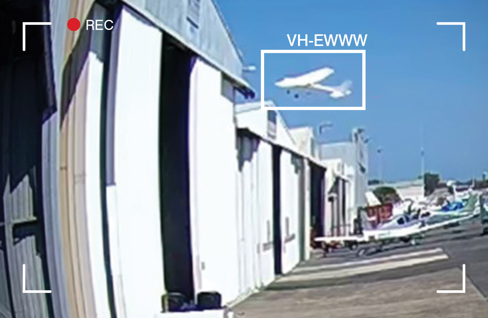 Image from CCTV footage showing VH-EWW passing close above hangars